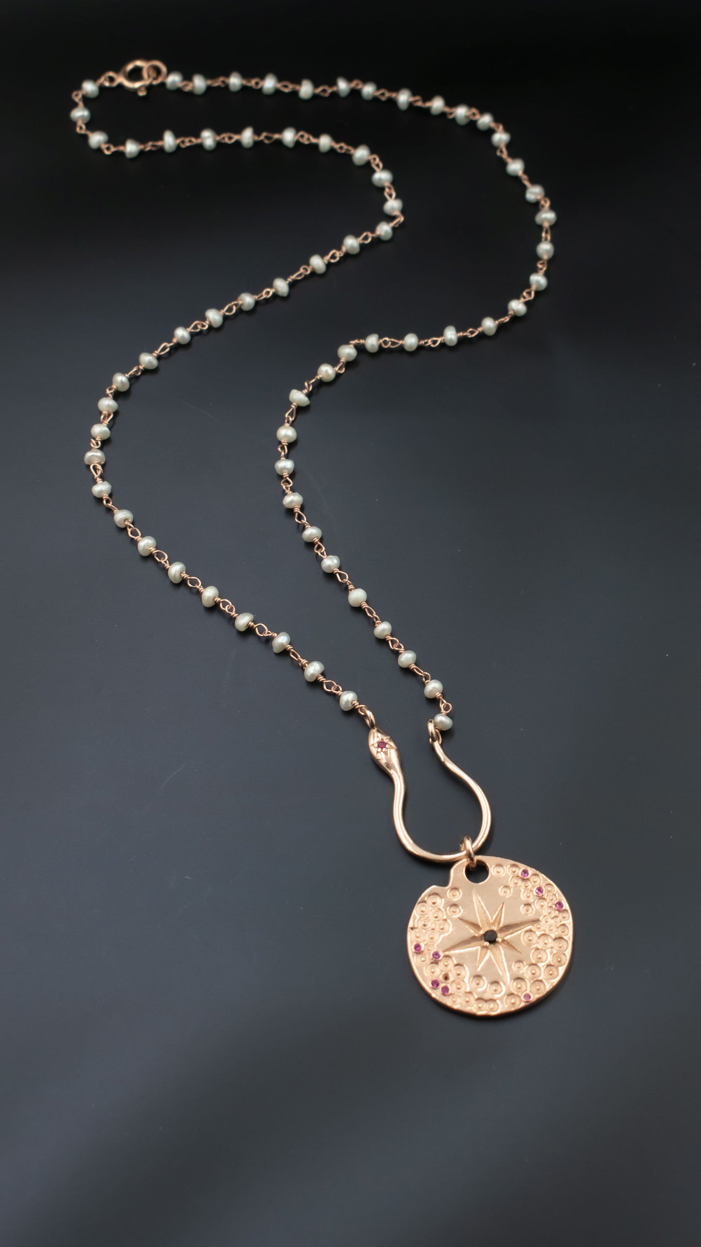 Zodiac sign pendant on a beautiful pearl necklace